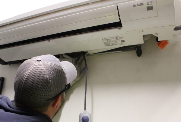 Commercial HVAC tech checking indoor unit