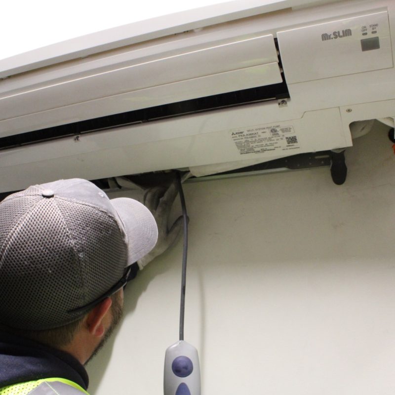 Commercial HVAC tech checking indoor unit