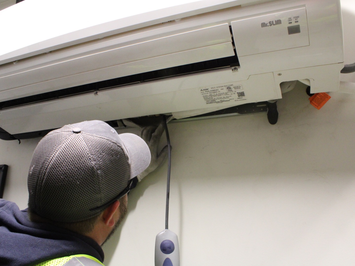 Commercial HVAC tech checking indoor unit