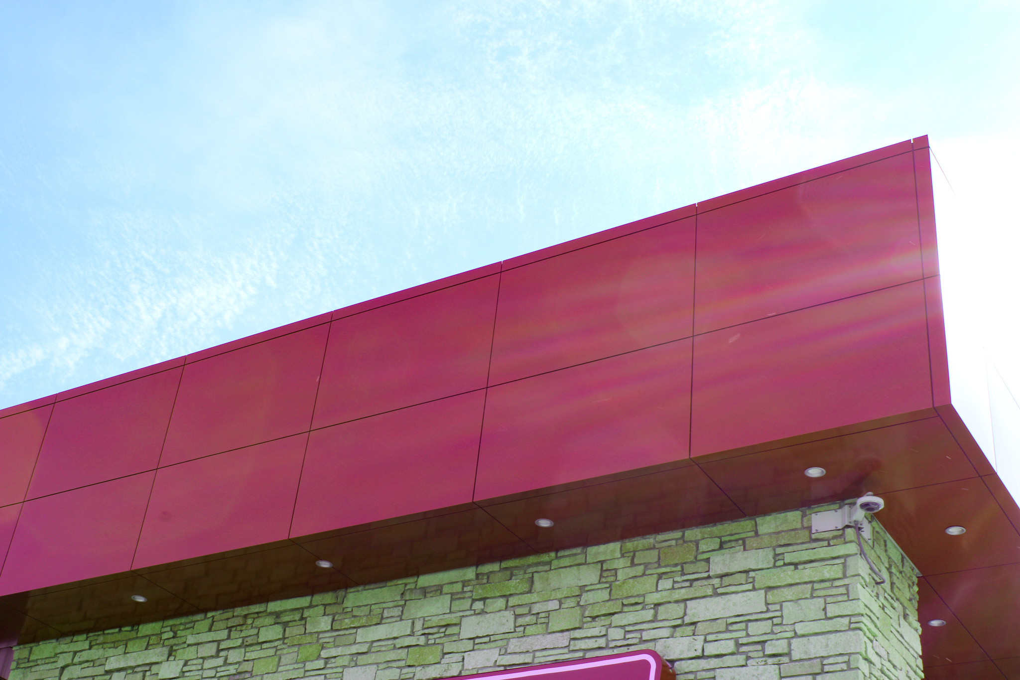 custom red panels detail on office building