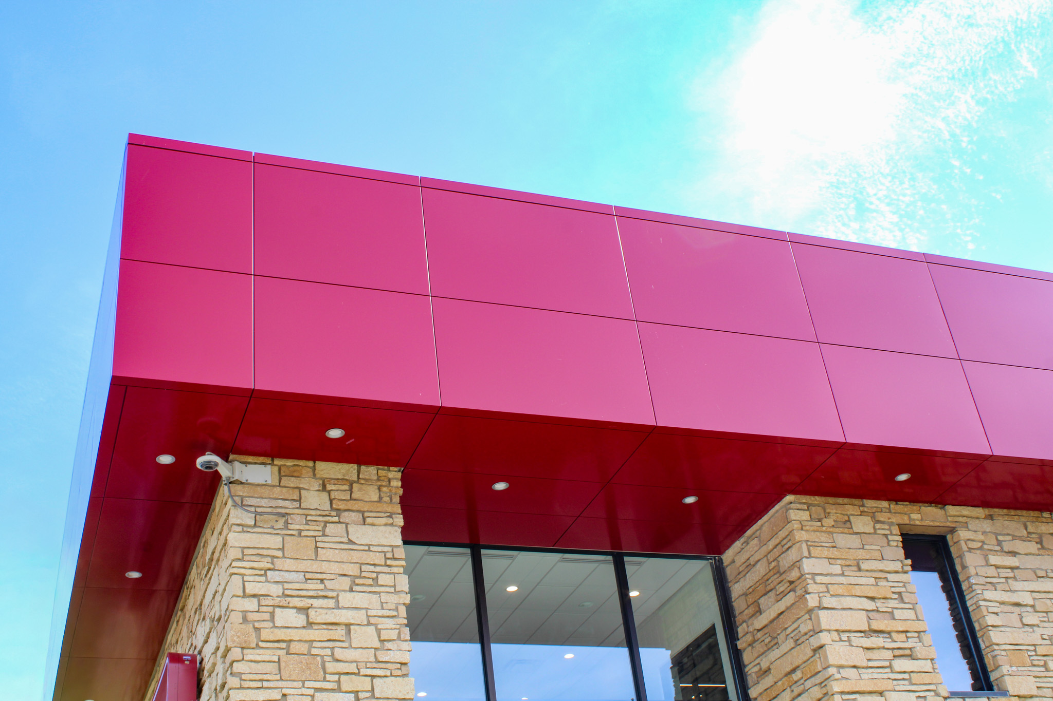 custom red panels detail on office building