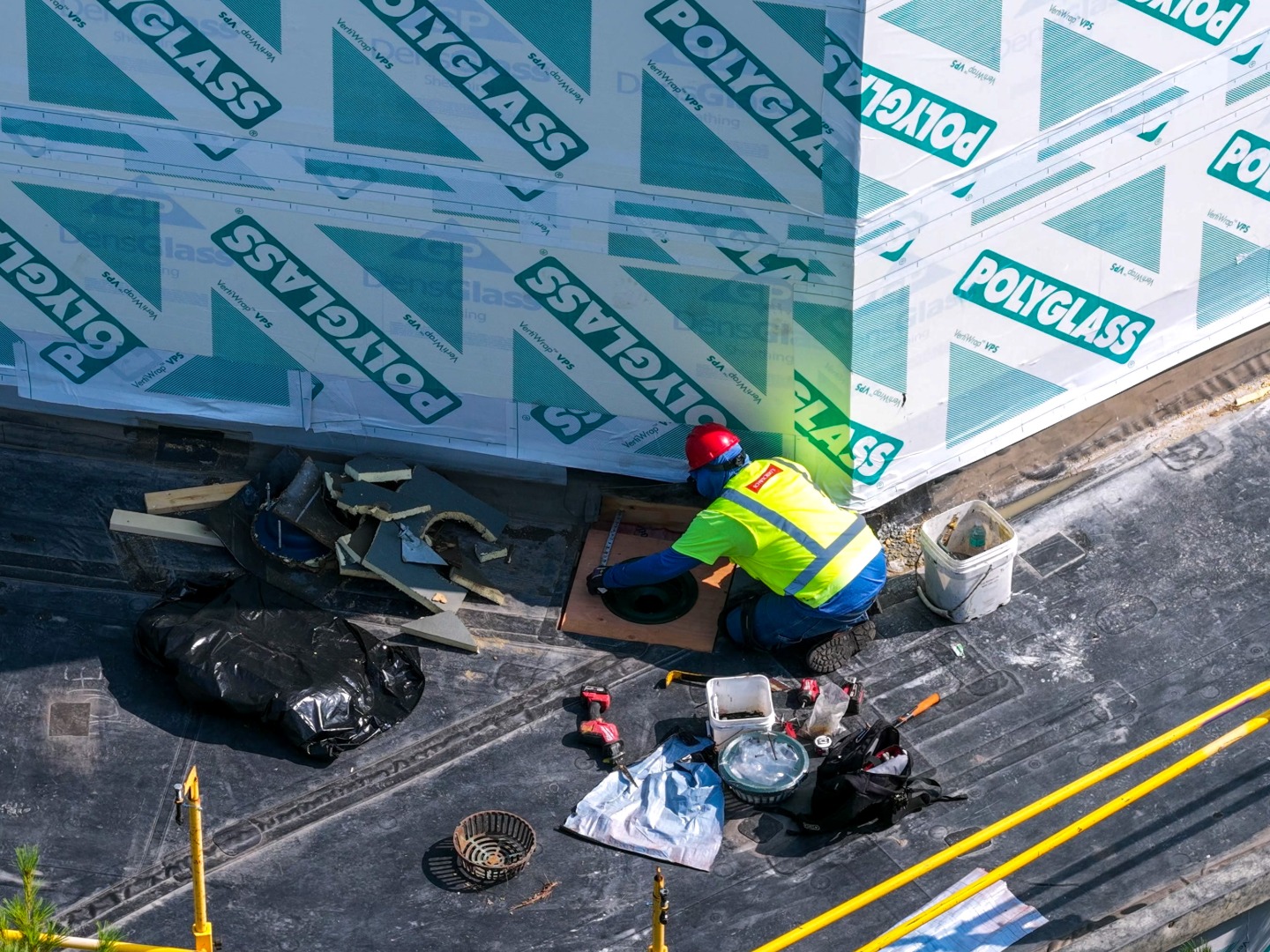 roofing service tech replacing roof drains
