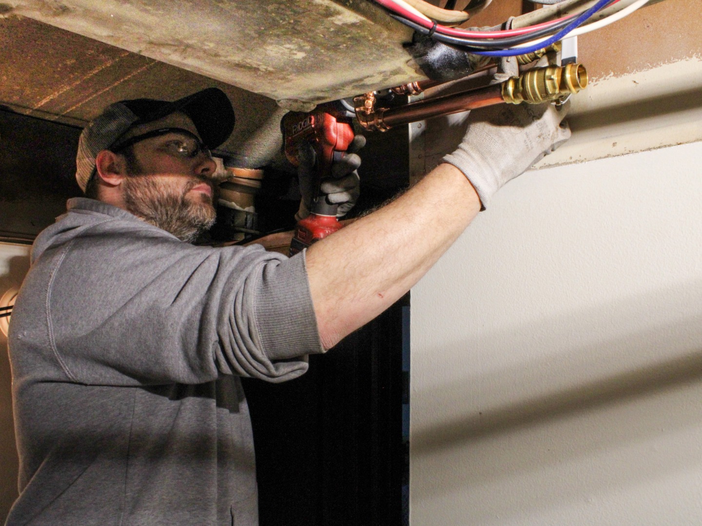plumbing journeyman fixing commercial pipe